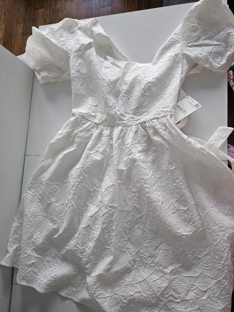 New White Babydoll Dress with Floral Texture open and tie back. Size Medium